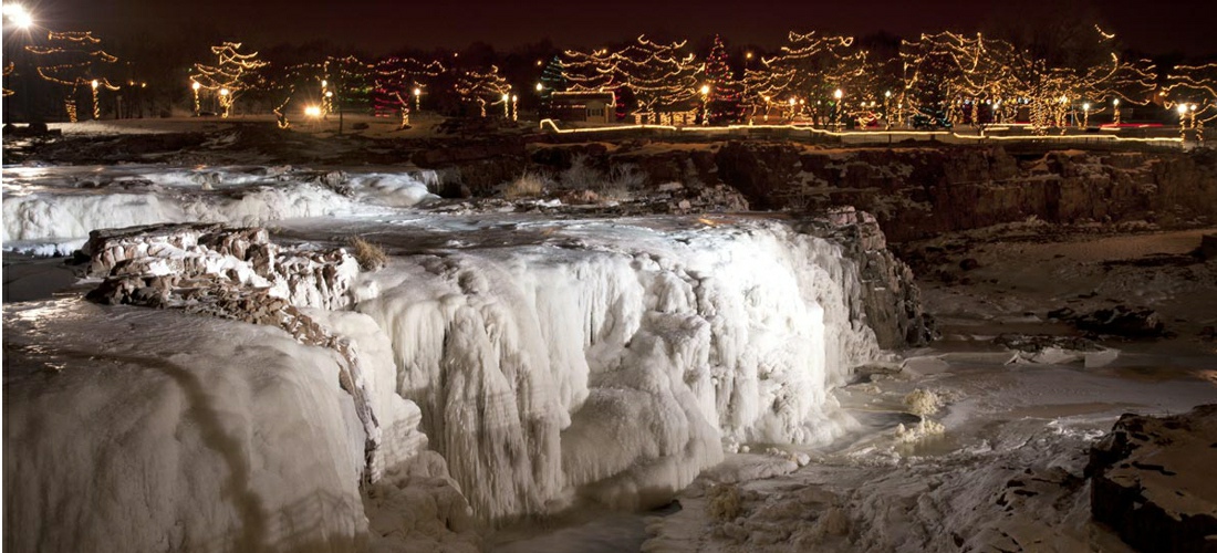 Falls Park in Sioux Falls, South Dakota features a three-tier waterfall.