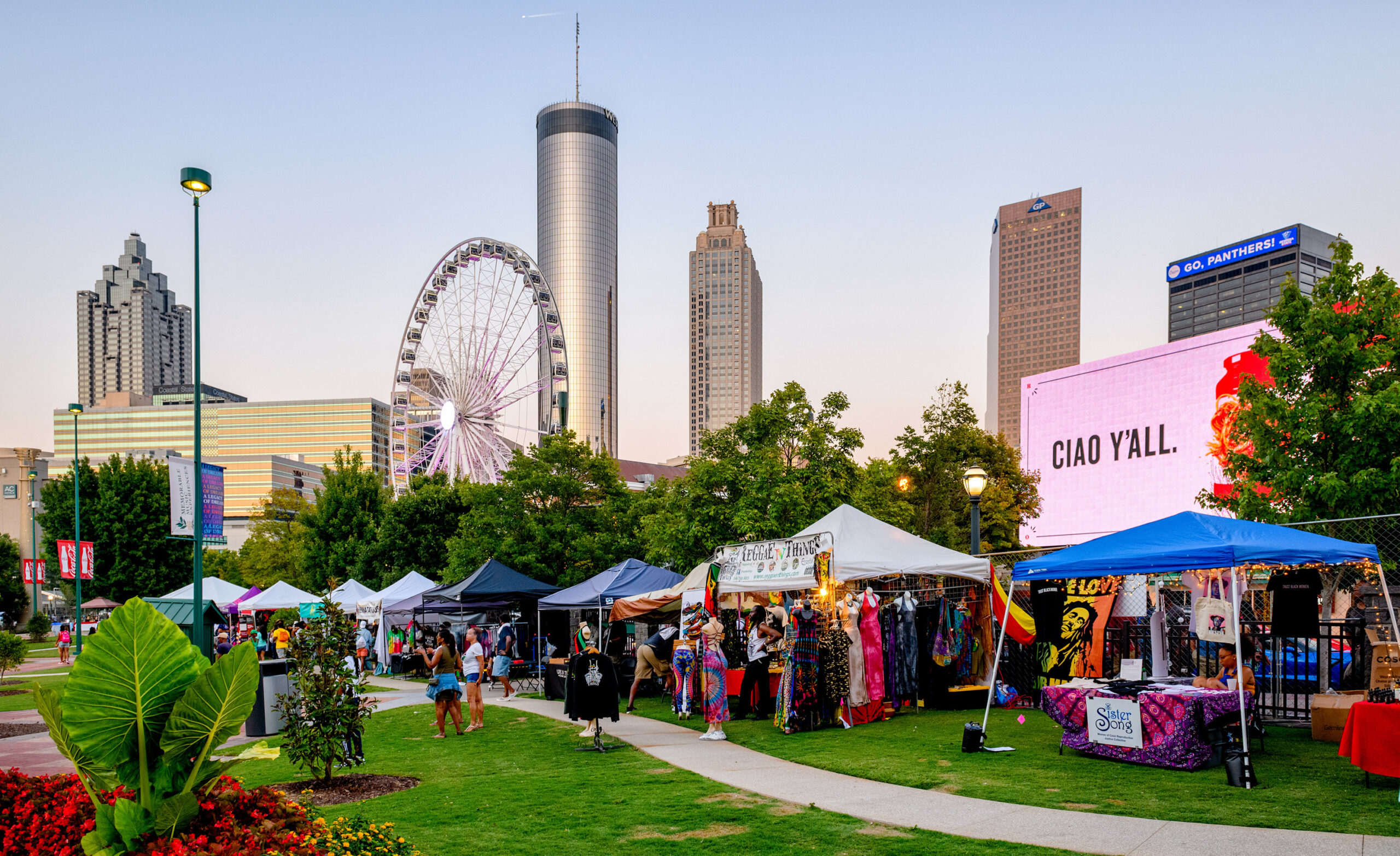 Evening shot of One MusicFest vendor booths featurng the Downtown Atlanta, Georgia, skyline.