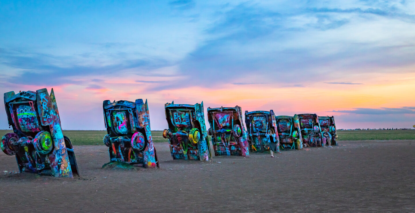 Sunset view of the colorful, half-buried cars at Cadillac Ranch in Amarillo, Texas
