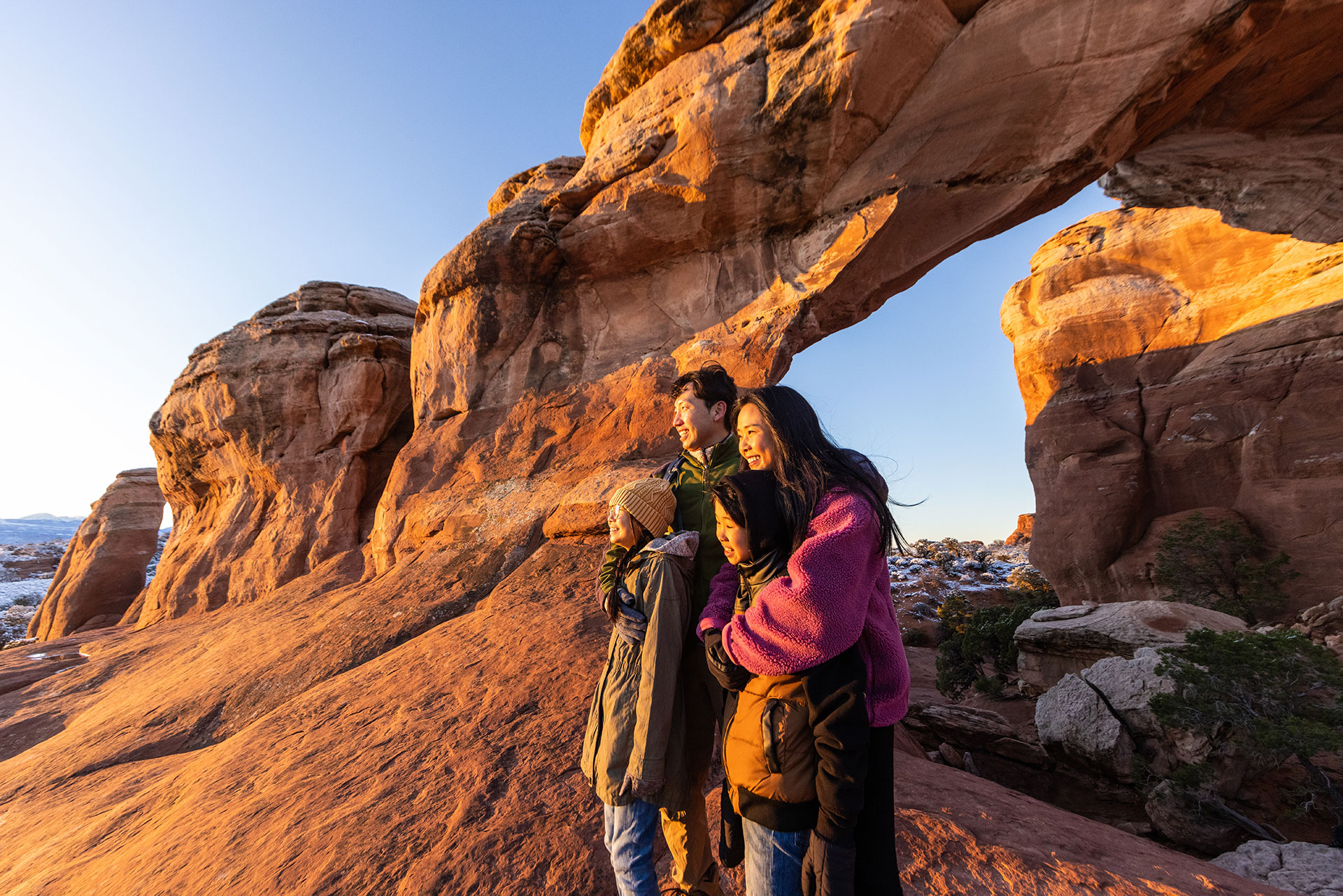 Family enjoying stunning scenery at Arches National Park in Utah