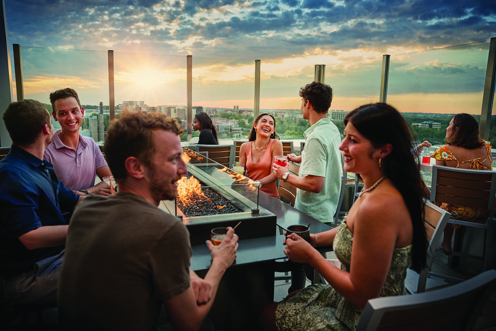 A group enjoys drinks and downtown views at a rooftop bar in Iowa City, Iowa; Credit: Travel Iowa