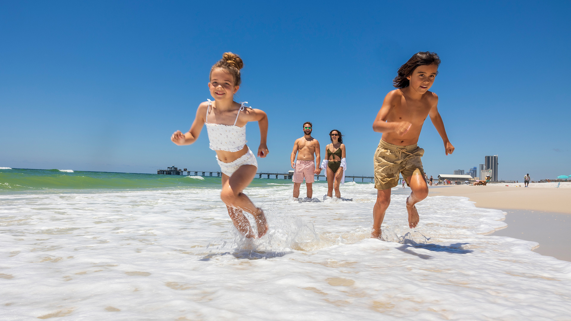 Family playing on the beach in Gulf Shores, Alabama