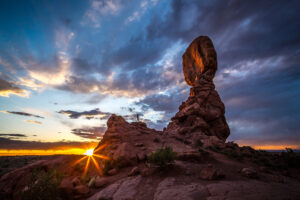 Hiker at Balanced Rock in Arches National Park in Utah