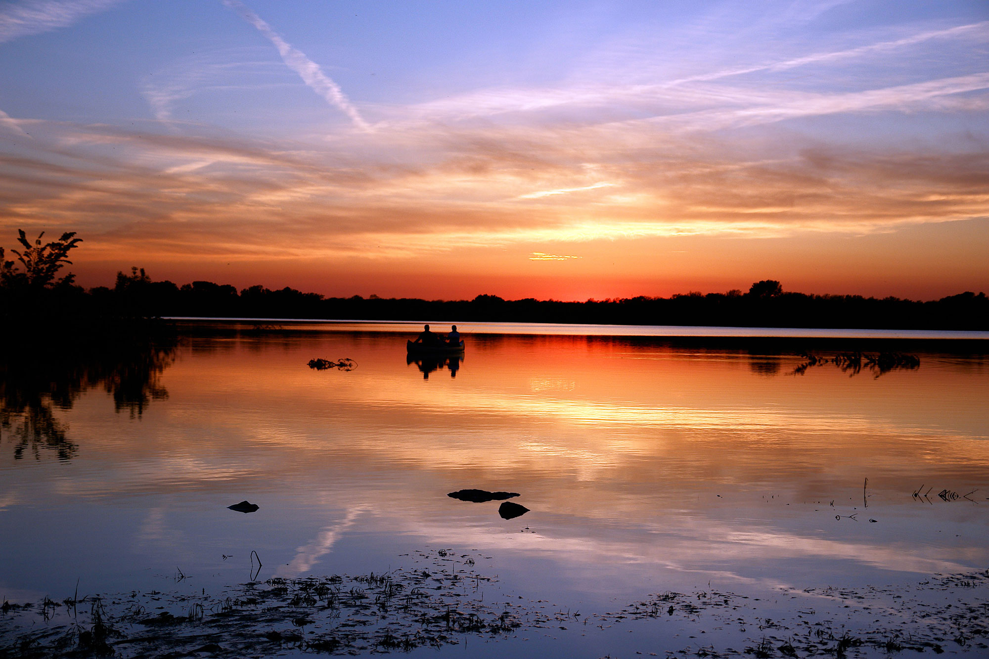 Anglers at sunset on a lake in Lincoln, Nebraska