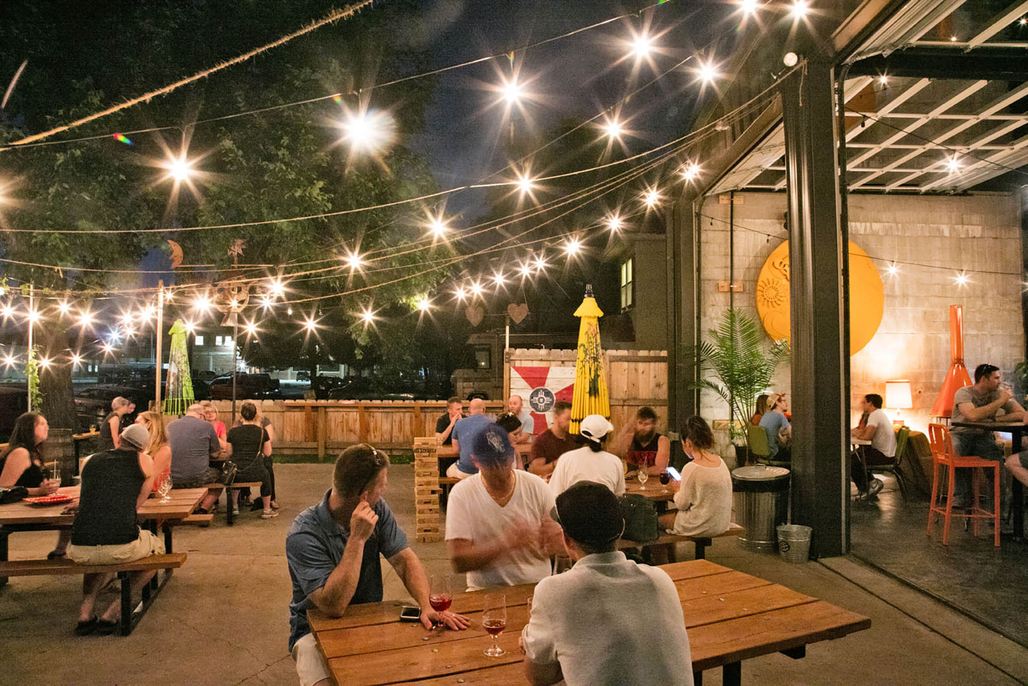 Enjoying an evening under the patio lights at Central Standard Brewing in Wichita, Kansas; Credit: Kansas Tourism