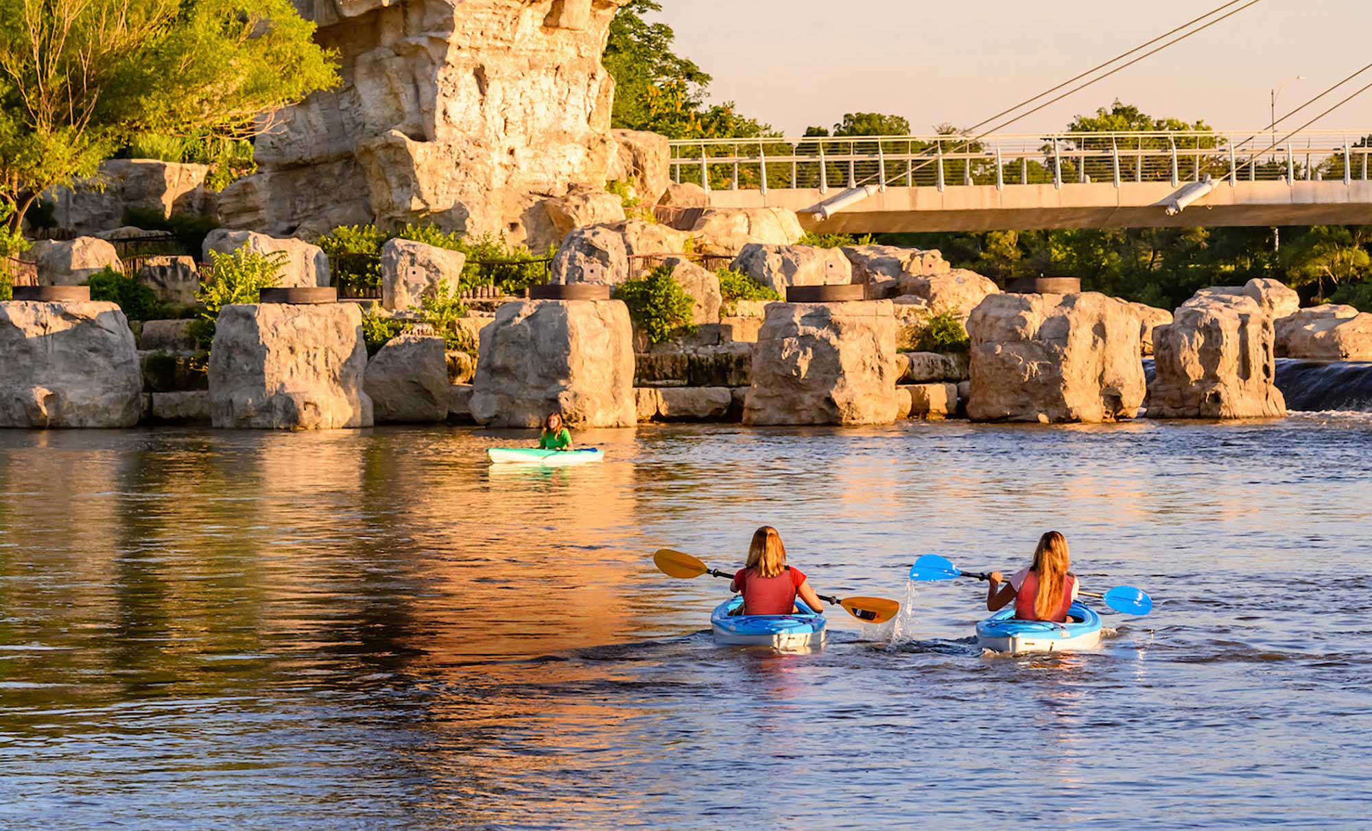 Kayaking the Arkansas River beneath the Keeper of the Plains statue in Wichita, Kansas; Credit: Kansas Tourism