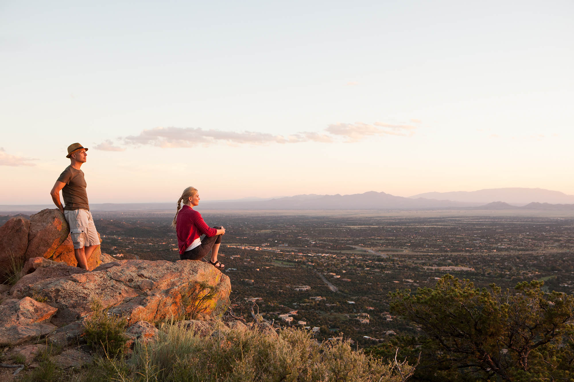 A couple takes in the view at the top of a mountain trail in Santa Fe, New Mexico