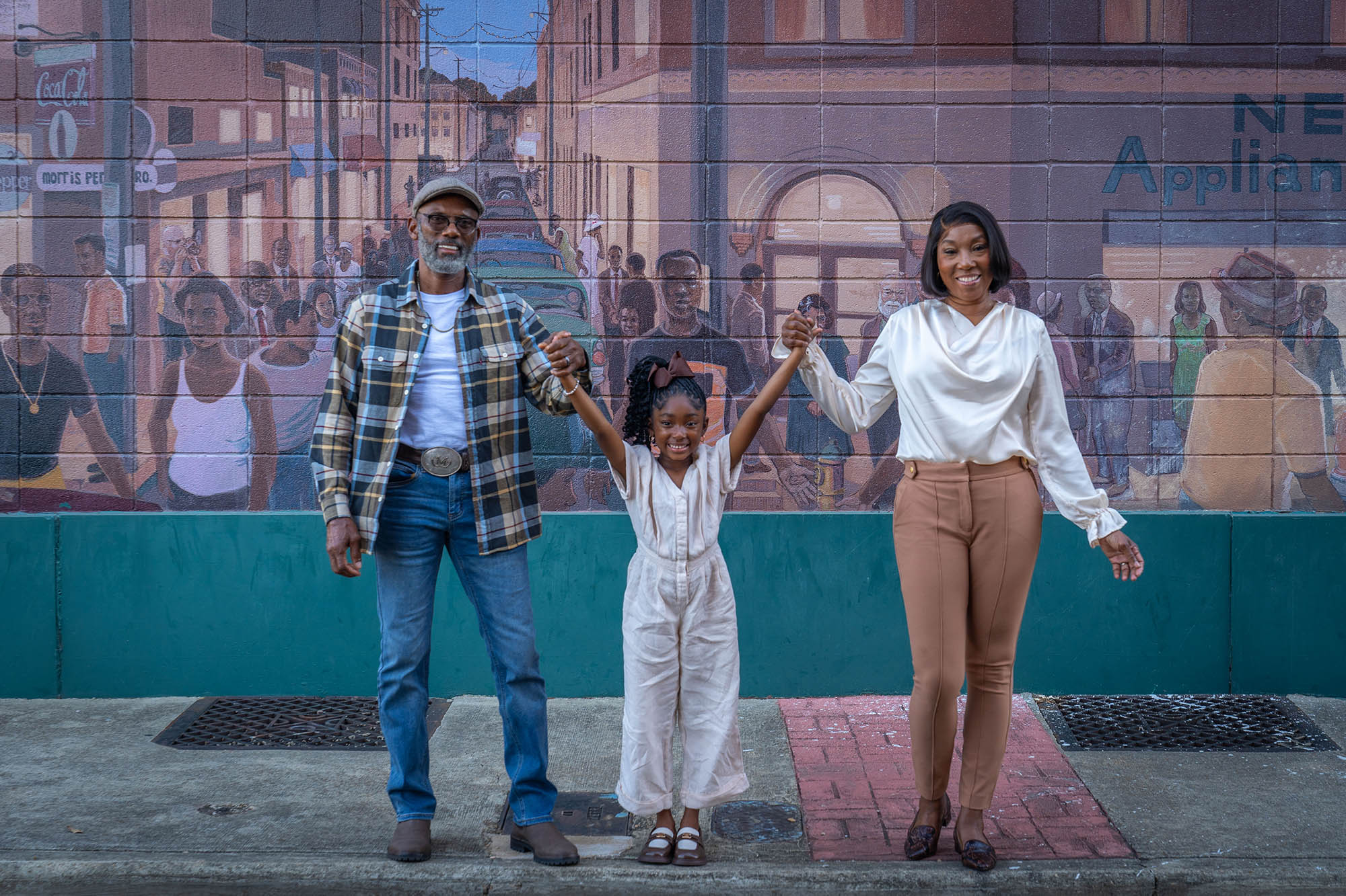 Posing in front of the Catfish Alley mural in Columbus, Mississippi