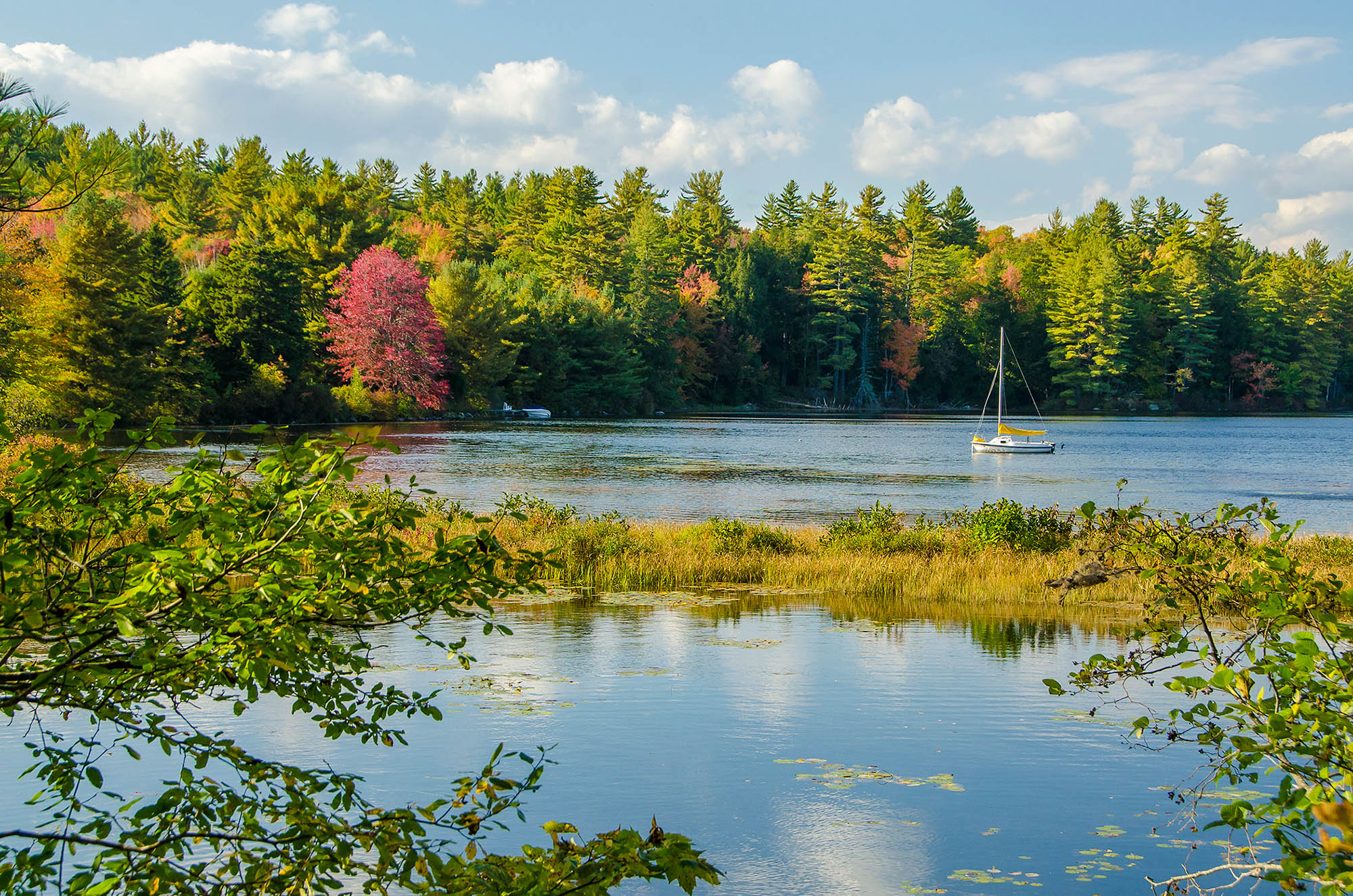 Scenic autumn view of a boat on Conway Lake in New Hampshire’s White Mountains