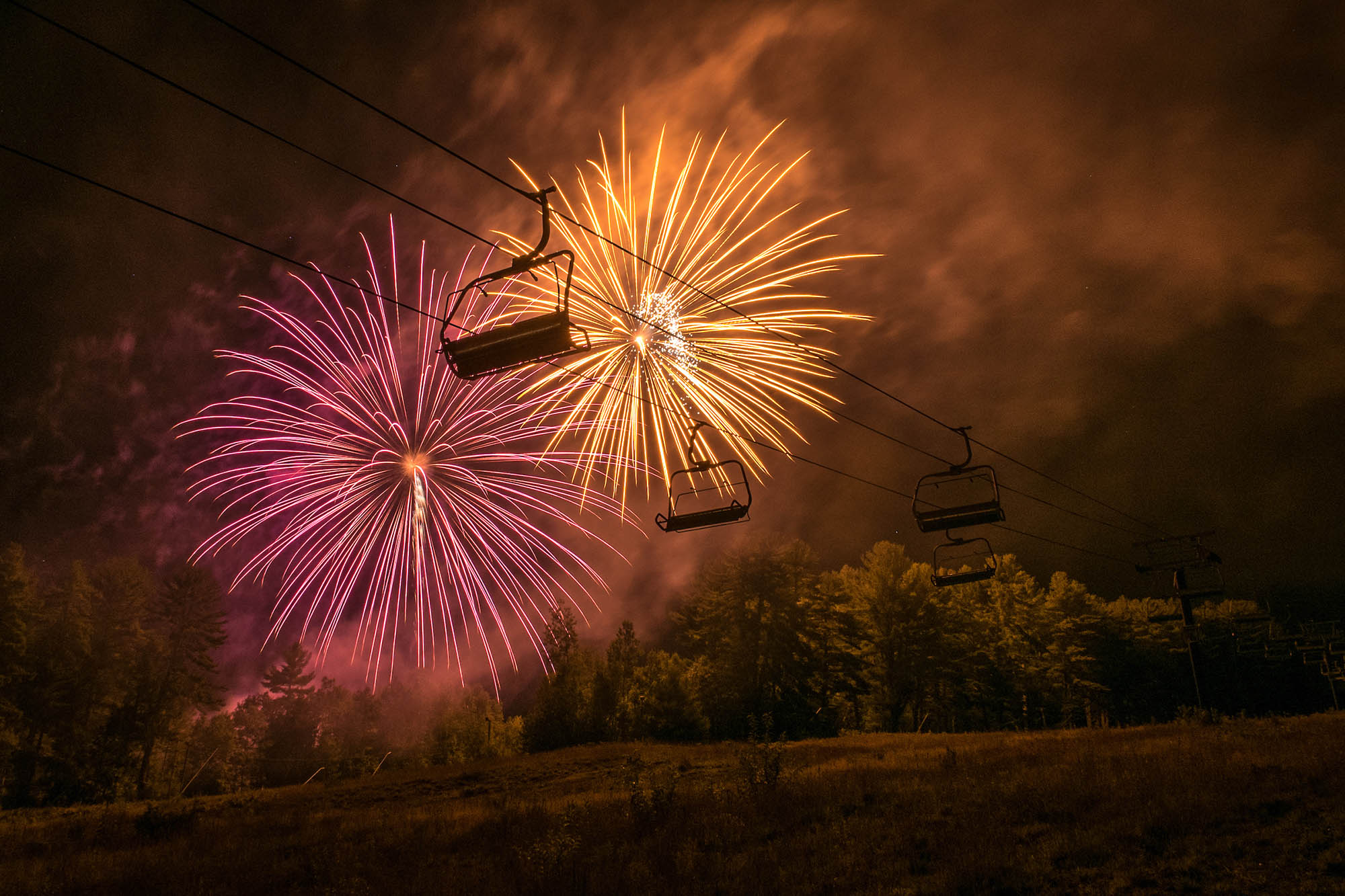 Chairlift with fireworks during the Arts Jubilee Summer Concert Series at Cranmore Mountain Resort in New Hampshire’s White Mountains