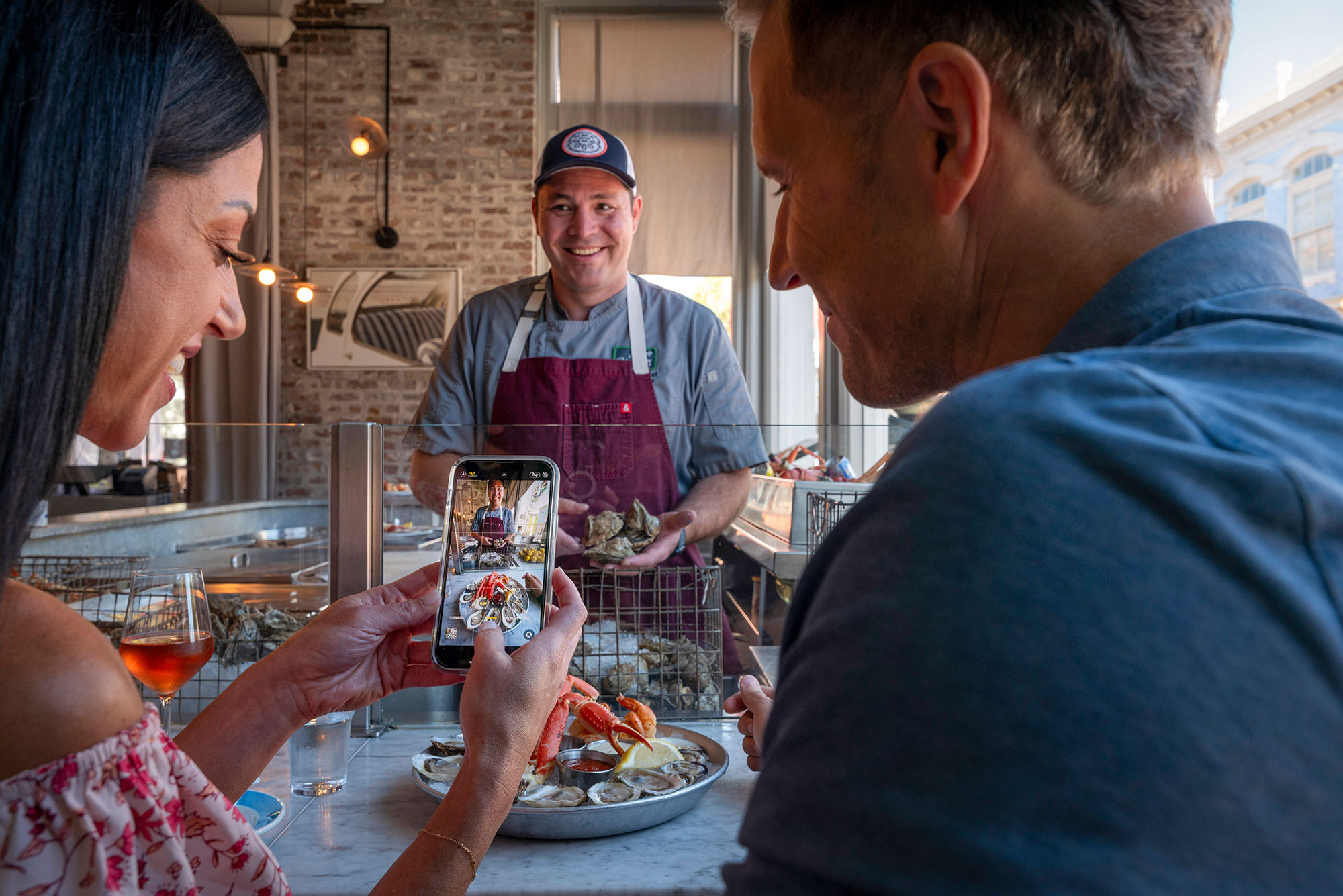 Visitors and chef at The Darling Oyster Bar in Charleston, South Carolina
