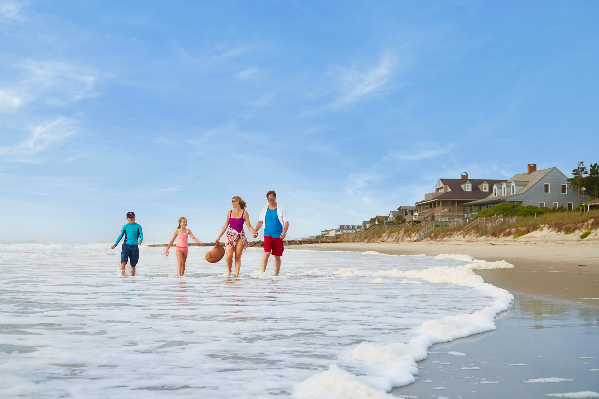Family strolling along a beach in South Carolina