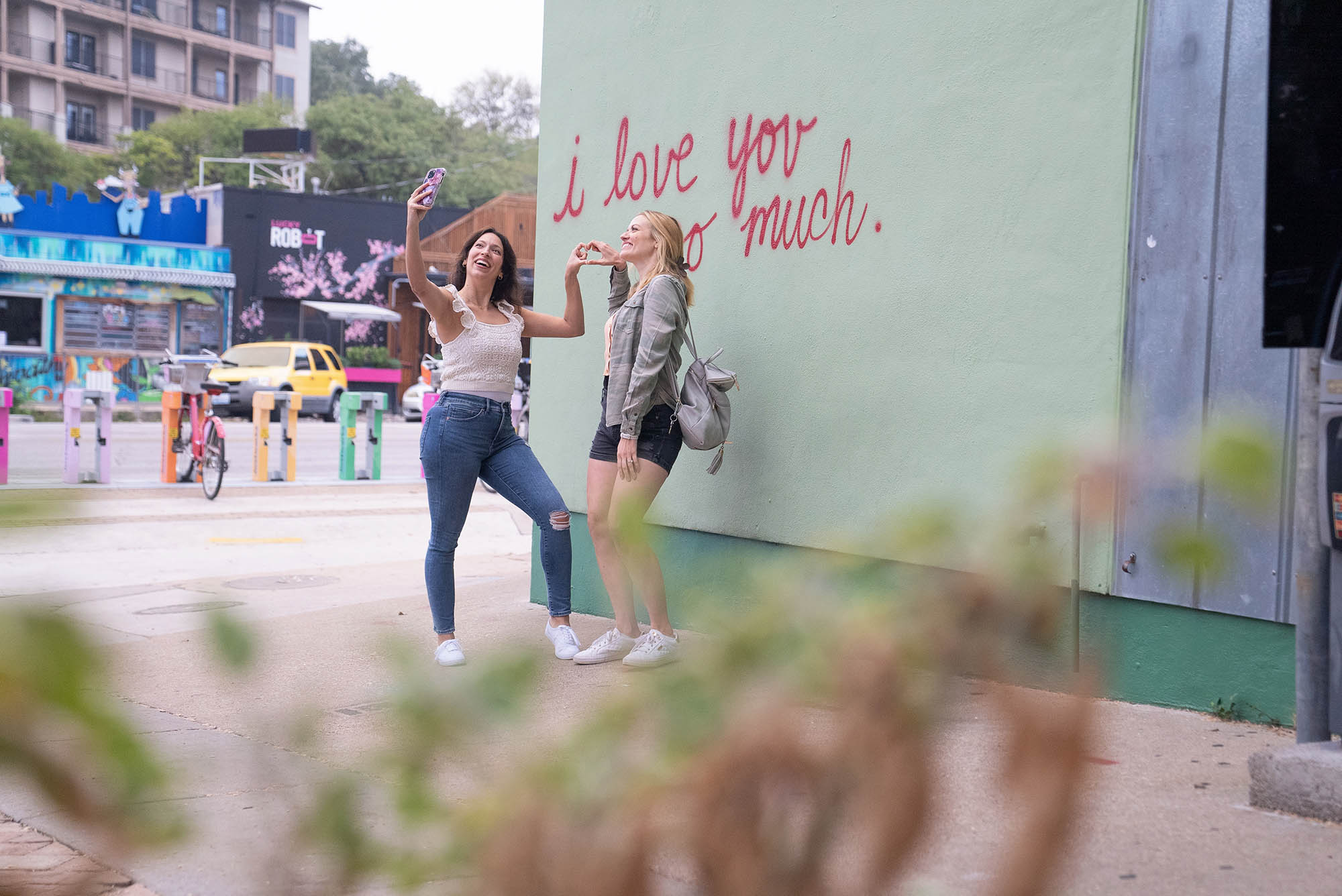 Posing for a selfie with the “I Love You So Much” mural in Austin, Texas.