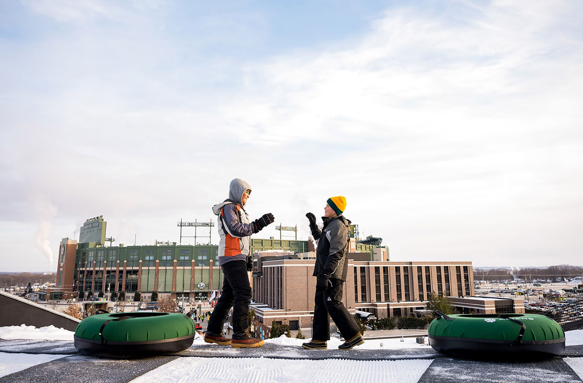 Visitors snow tubing at Titletown near Lambeau Field in Green Bay, Wisconsin; Credit: Discover Green Bay
