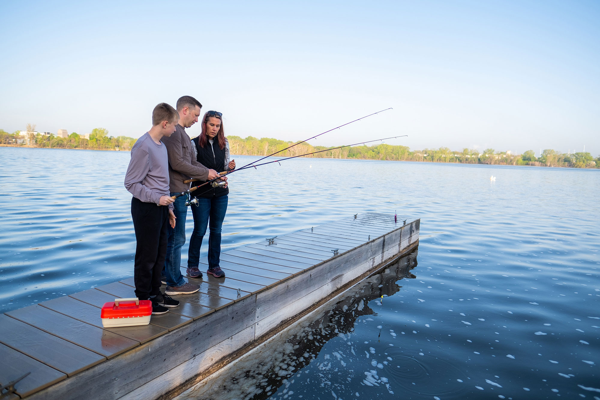 Family fishing the Fox River from Voyageur Park in Green Bay, Wisconsin
