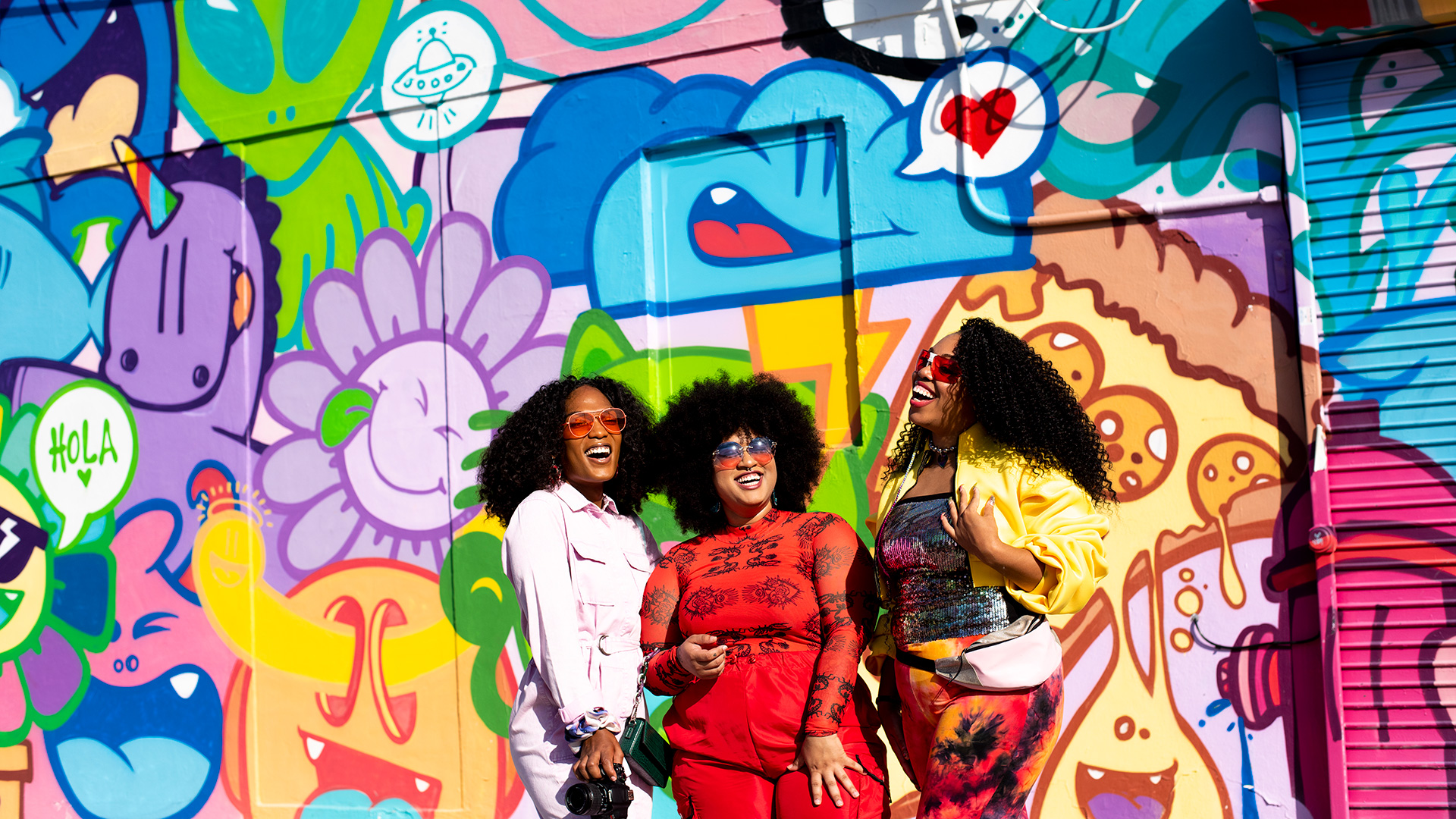 Posing with a colorful mural in Wynwood, Miami, Florida
