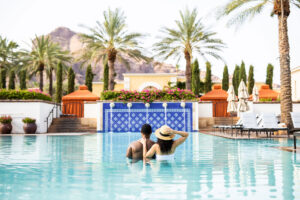 Couple enjoying the pool at the Omni Scottsdale Resort & Spa at Montelucia in Scottsdale, Arizona.