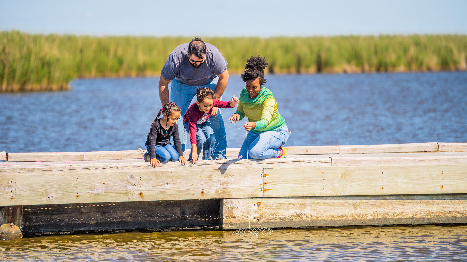 Family fishing at a park on the Creole Nature Trail in Lake Charles, Louisiana