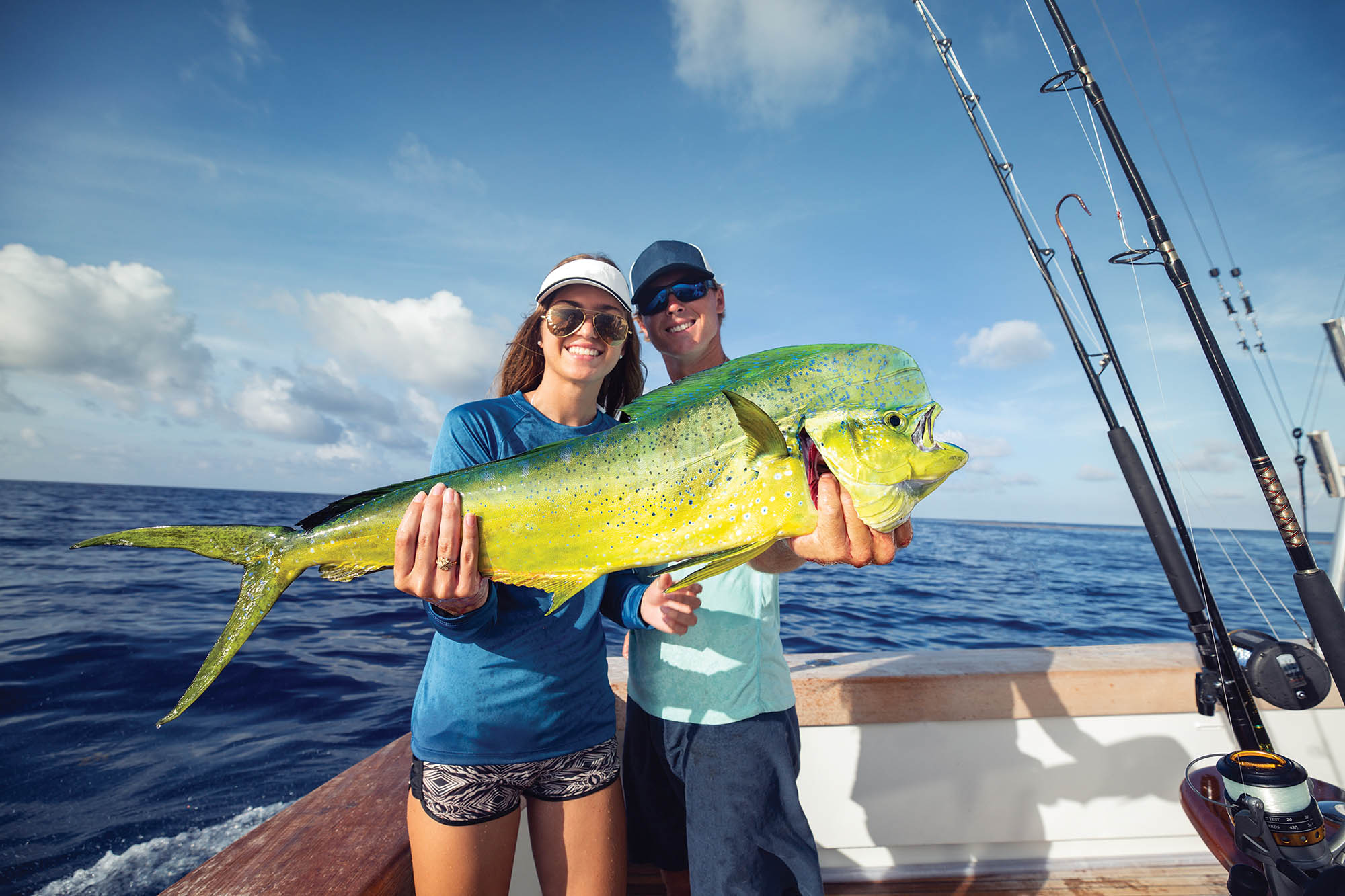 Showing off a mahi-mahi caught in The Florida Keys, Florida; Credit: Monroe County Tourism 
