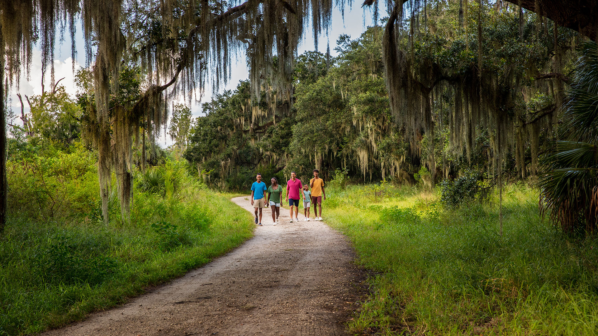 A family on a walking trail at Circle B Bar Reserve in Polk County, Florida