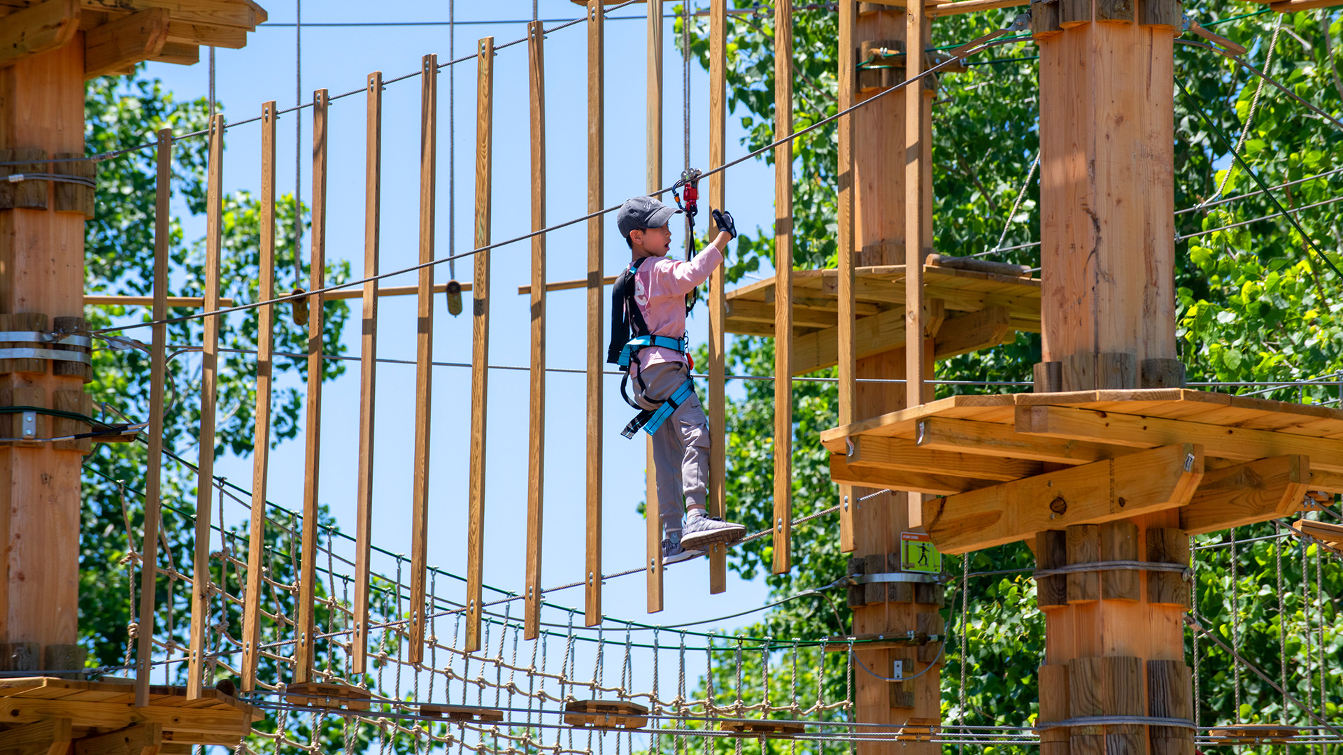 Tackling a ropes course at Go Ape Zipline & Adventure Park in Sugar Land, Texas