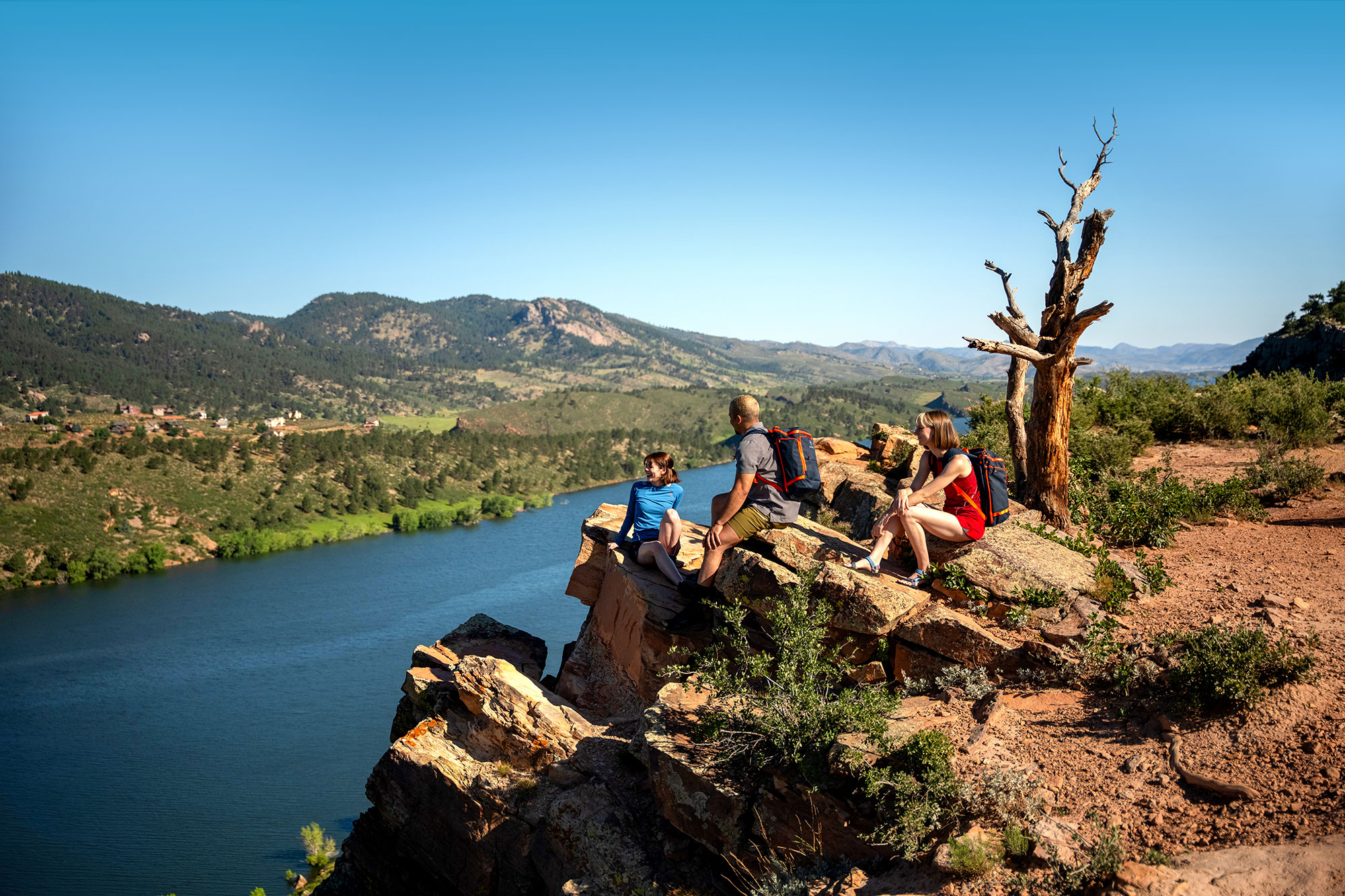 Hikers taking a break on Duncan’s Ridge overlooking Horsetooth Reservoir in Fort Collins, Colorado; Credit: Visit Fort Collins