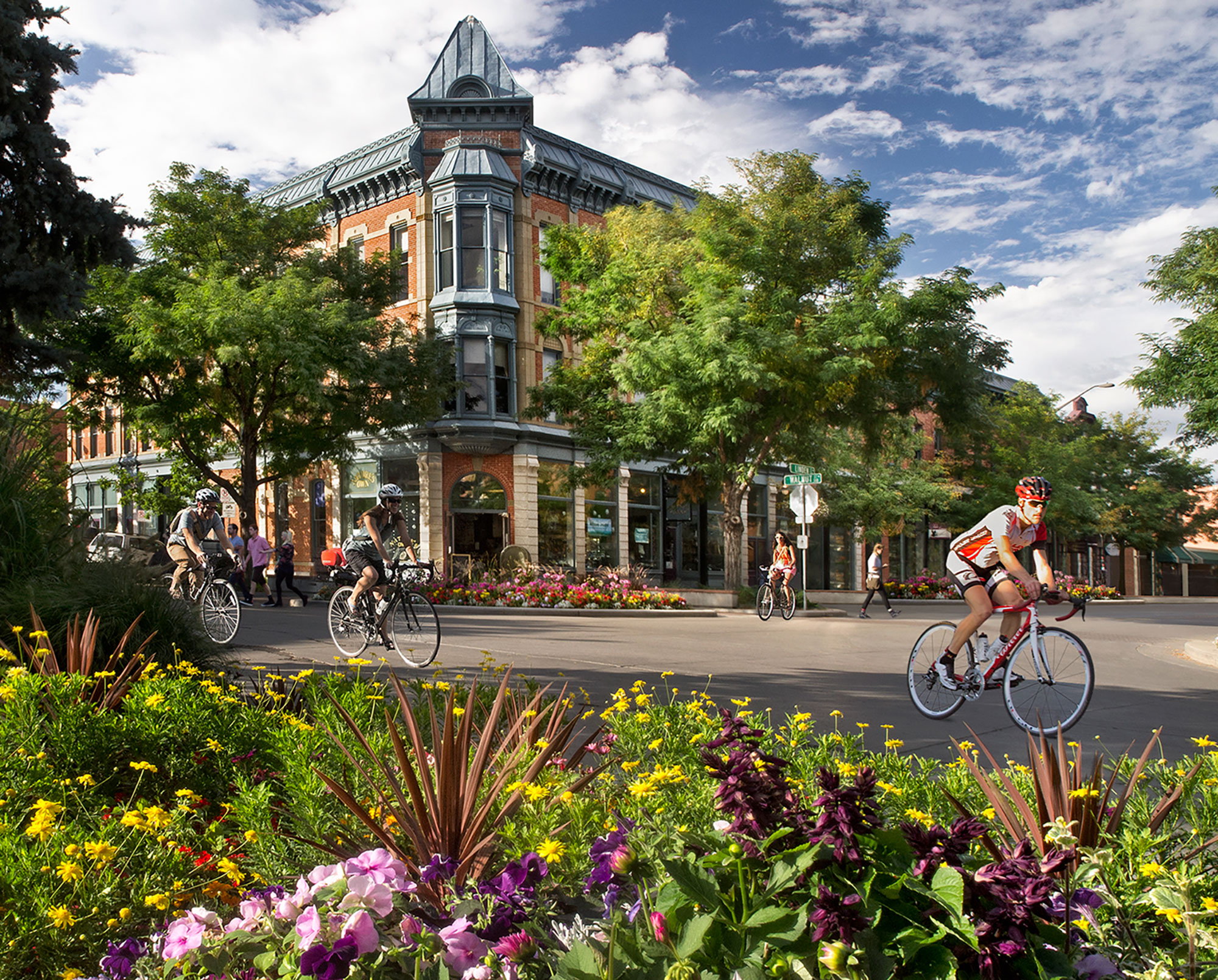 Cyclists passing the historic Linden Hotel in downtown Fort Collins, Colorado; Credit: Tim O’Hara