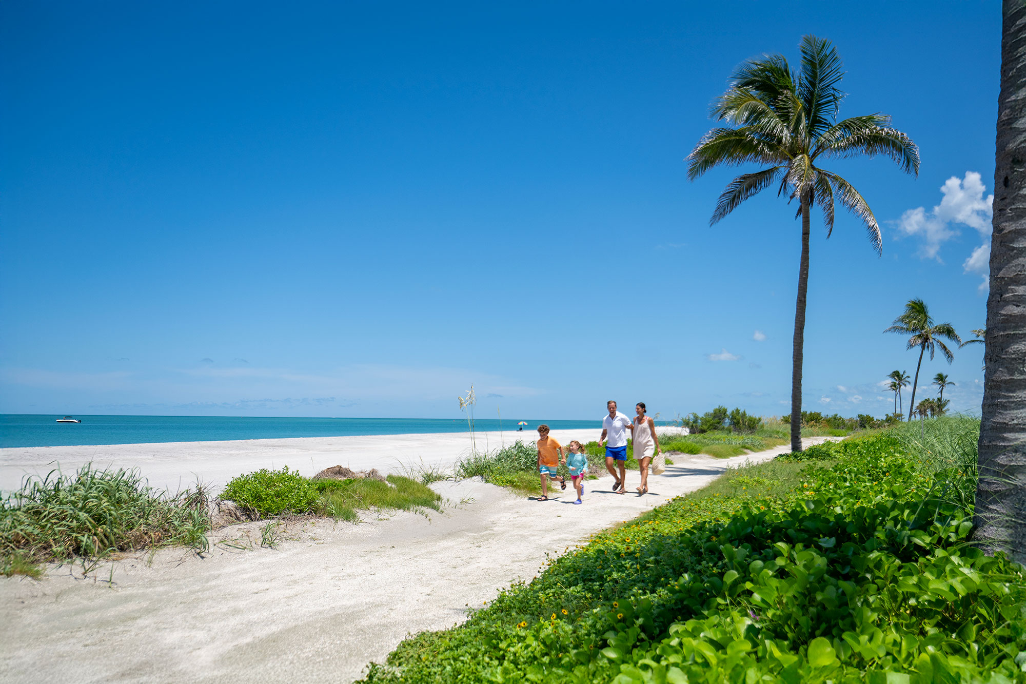 Family walking along the beach on Captiva Island, Florida; Credit: Visit Fort Myers