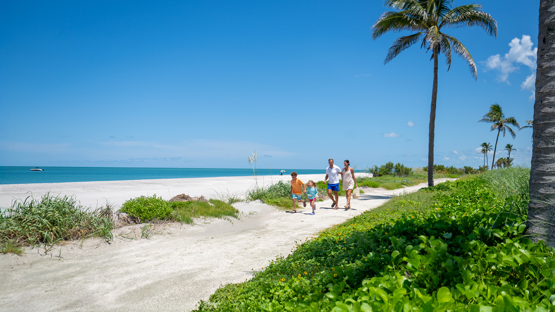 Family walking along the beach on Captiva Island, Florida