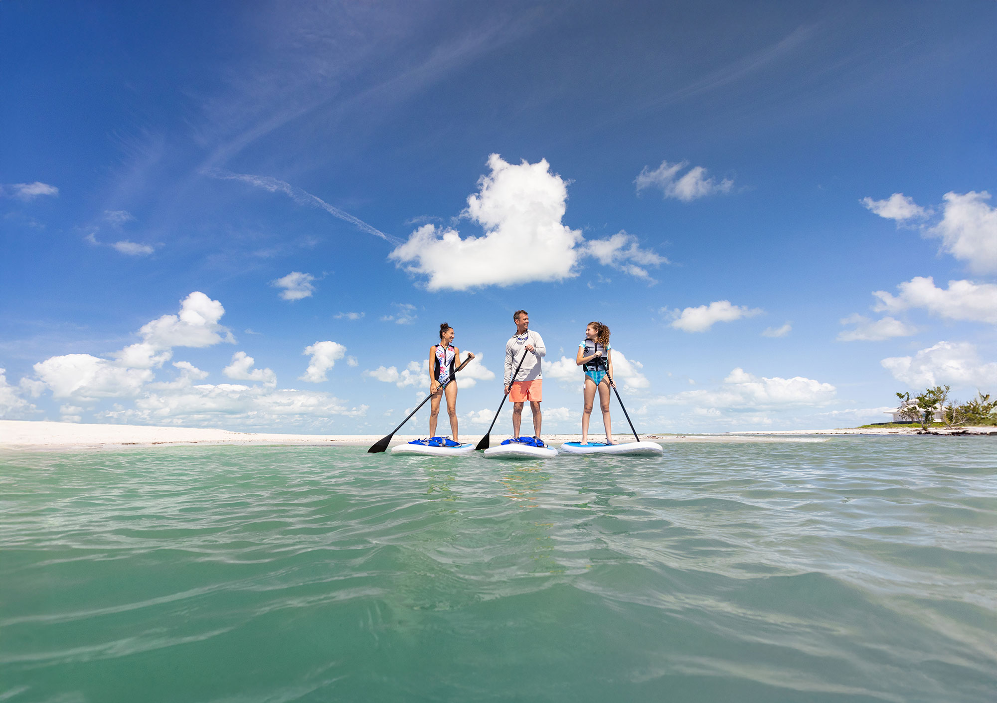 Family paddleboarding near Naples, Florida