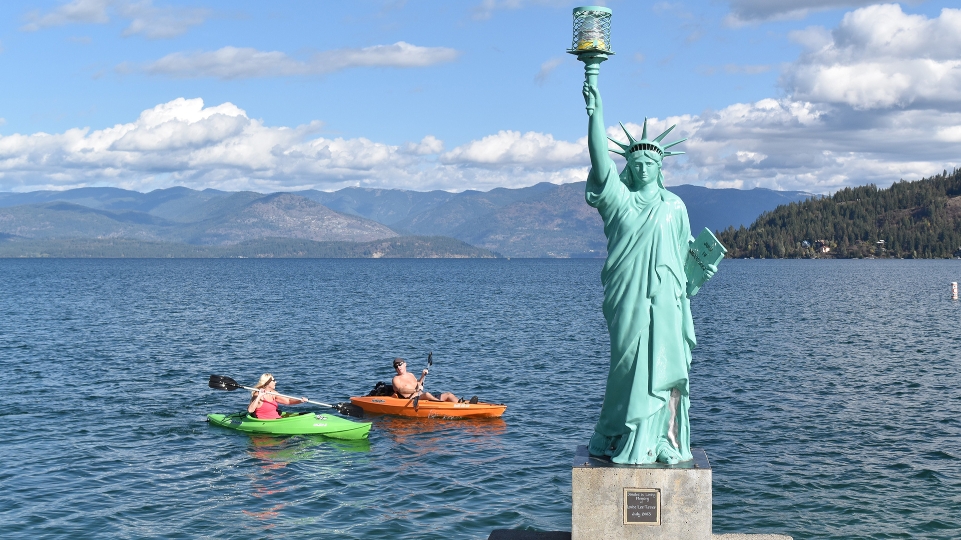Kayakers on Lake Pend Oreille and Lady Liberty statue on Liberty Pier of Sandpoint City Beach Park in Sandpoint, Idaho; Credit: Keokee