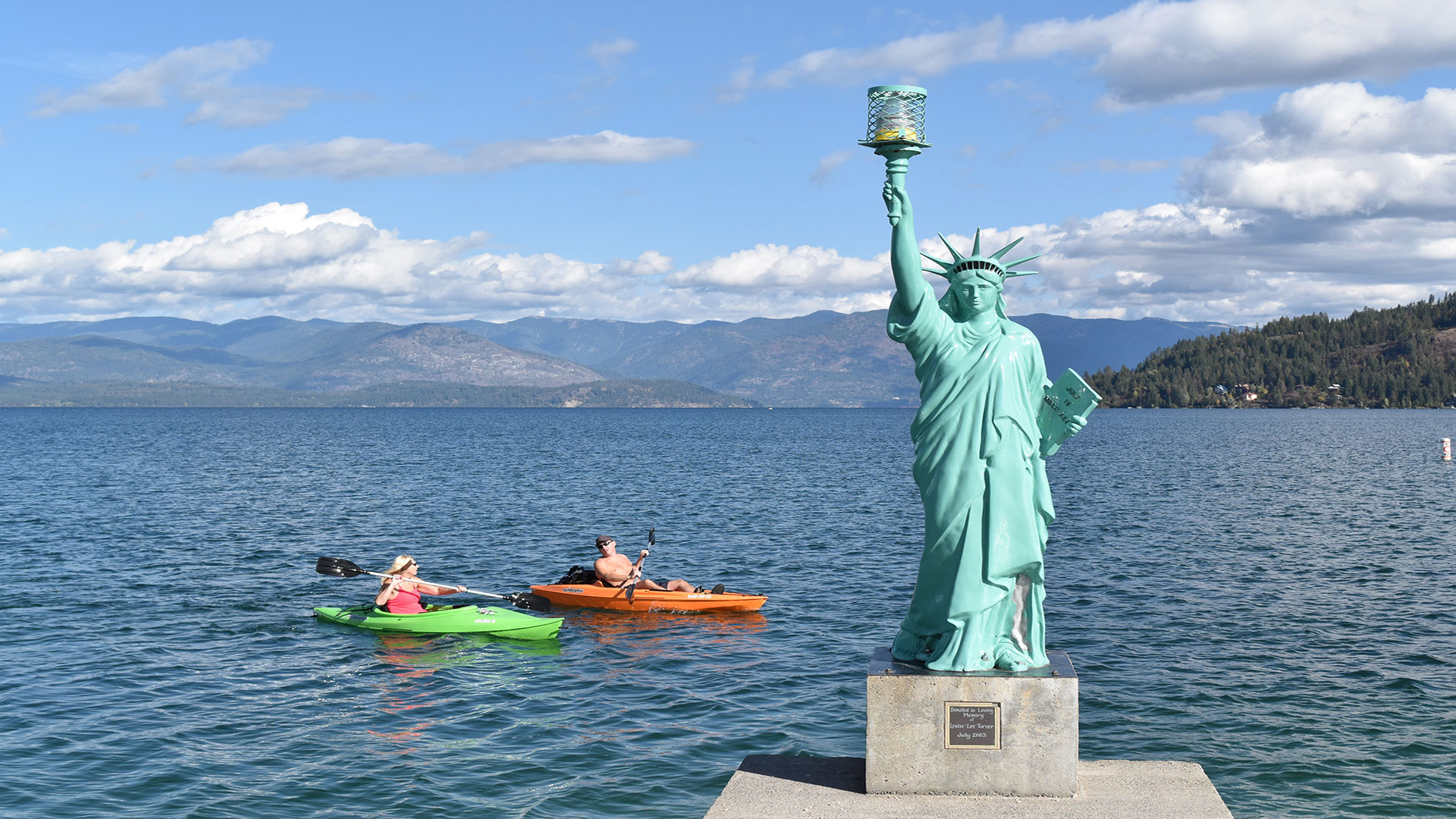 Kayakers on Lake Pend Oreille and Lady Liberty statue on Liberty Pier of Sandpoint City Beach Park in Sandpoint, Idaho; Credit: Keokee