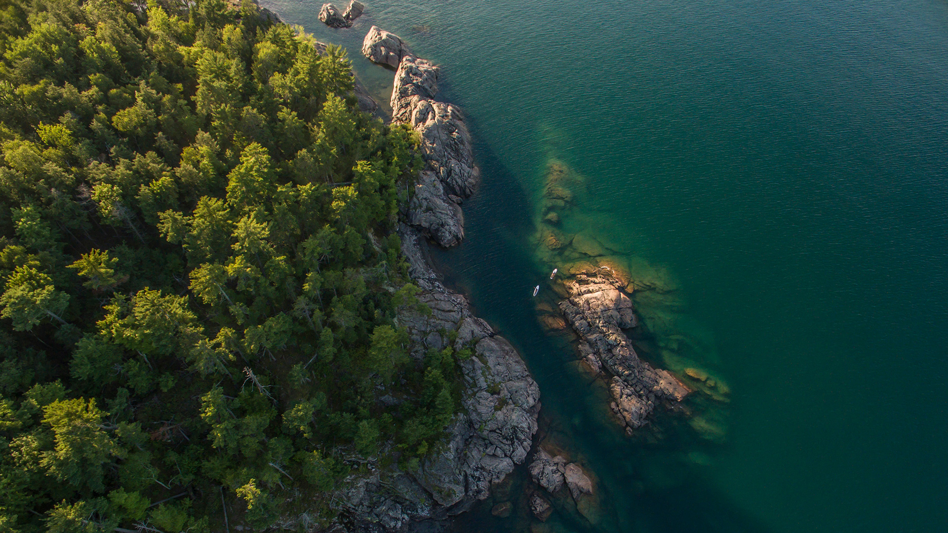 Aerial view of two paddleboarders near the Black Rocks of Presque Isle in Marquette, Michigan; Credit: Travel Marquette