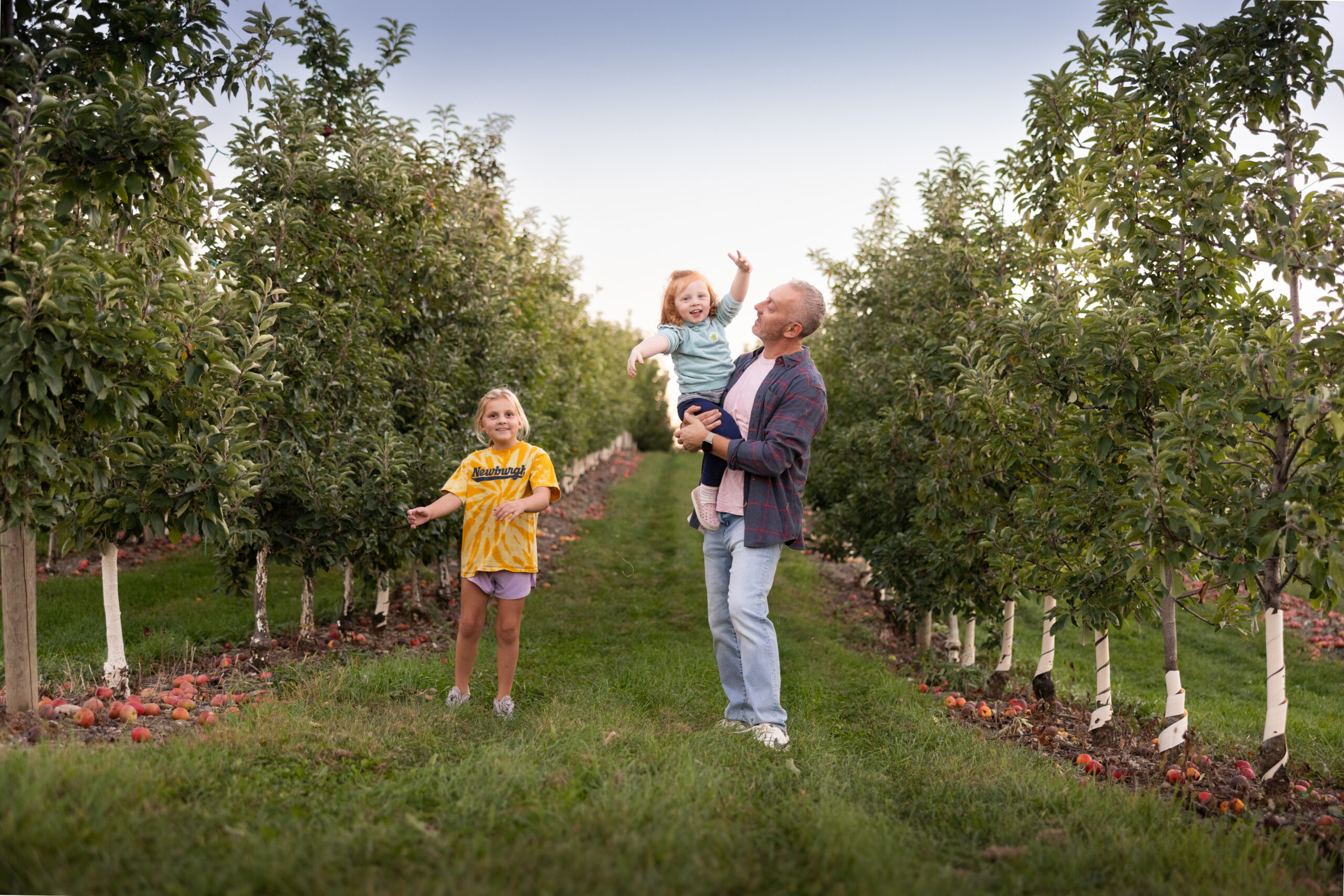 Family picking apples at the Angry Orchard Cider House in Walden, New York
