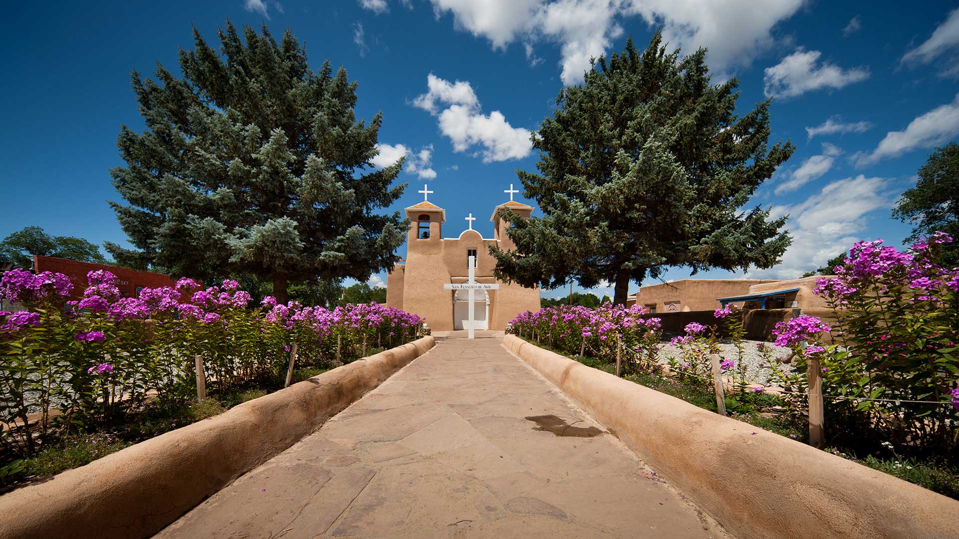 Flowers along the entrance to San Francisco de Asis Mission in Taos, New Mexico
